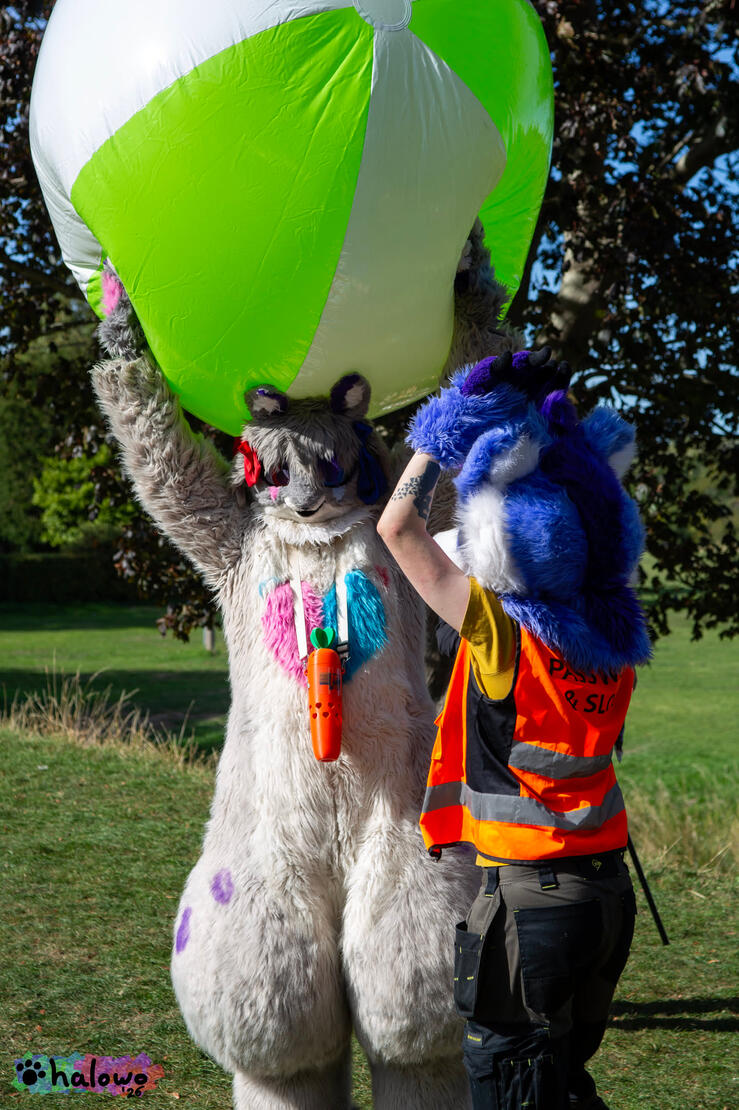 Hino holding a comically large beach ball